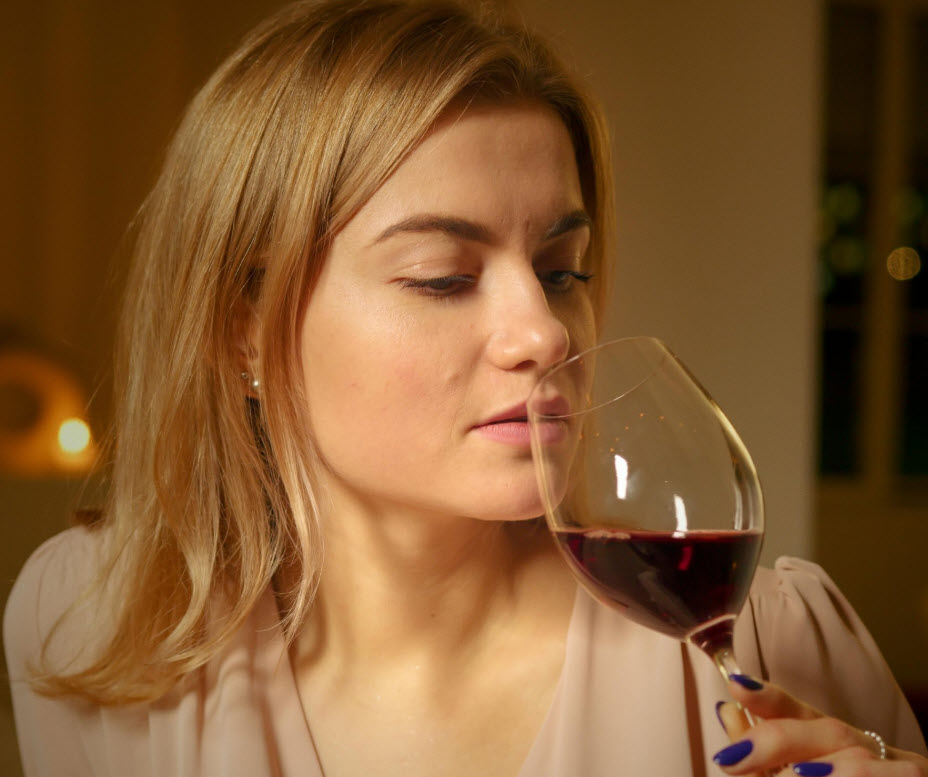 woman smelling wine